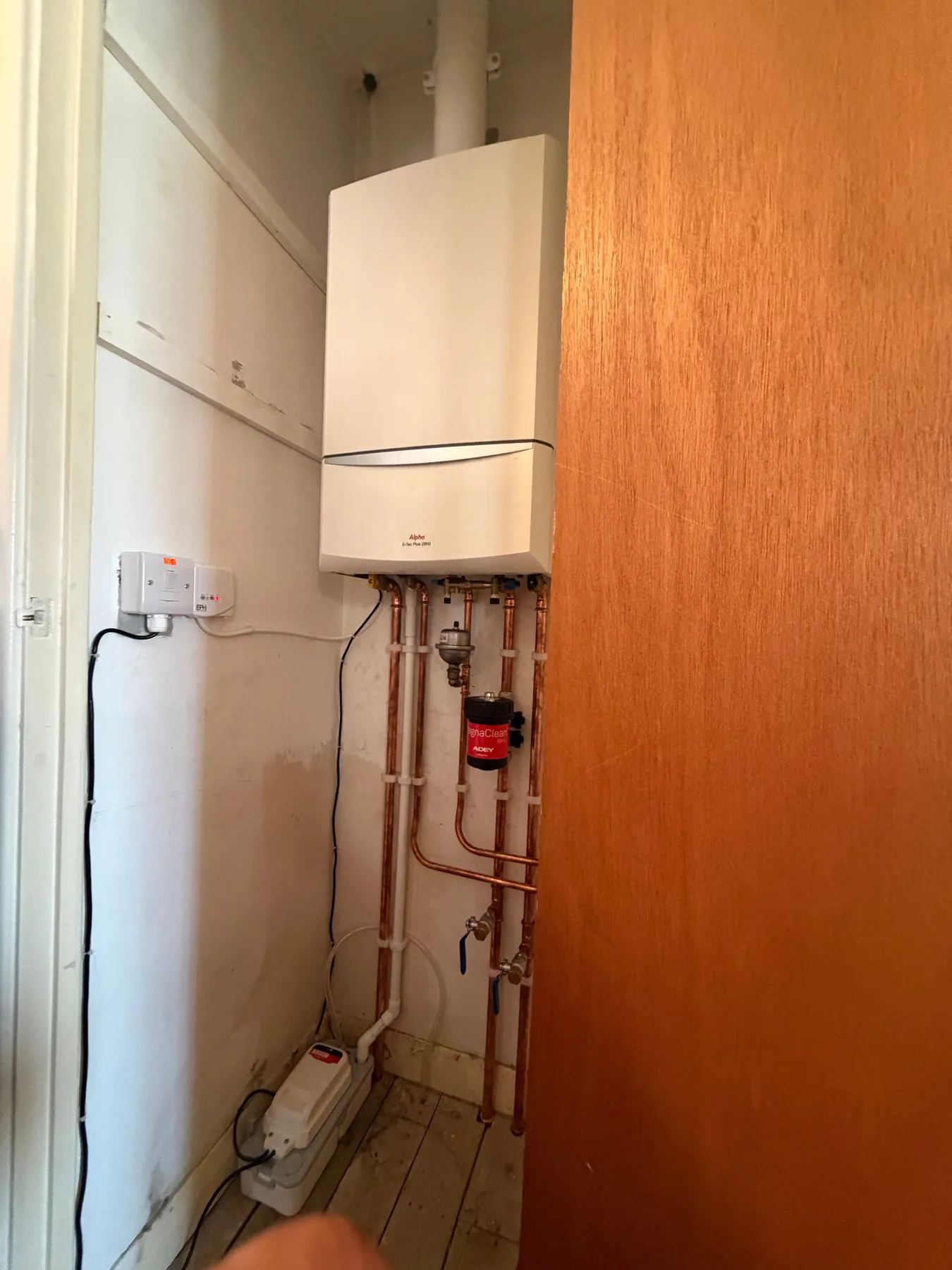 Vaillant combi boiler installed in a cupboard with new copper pipework and a magnetic filter