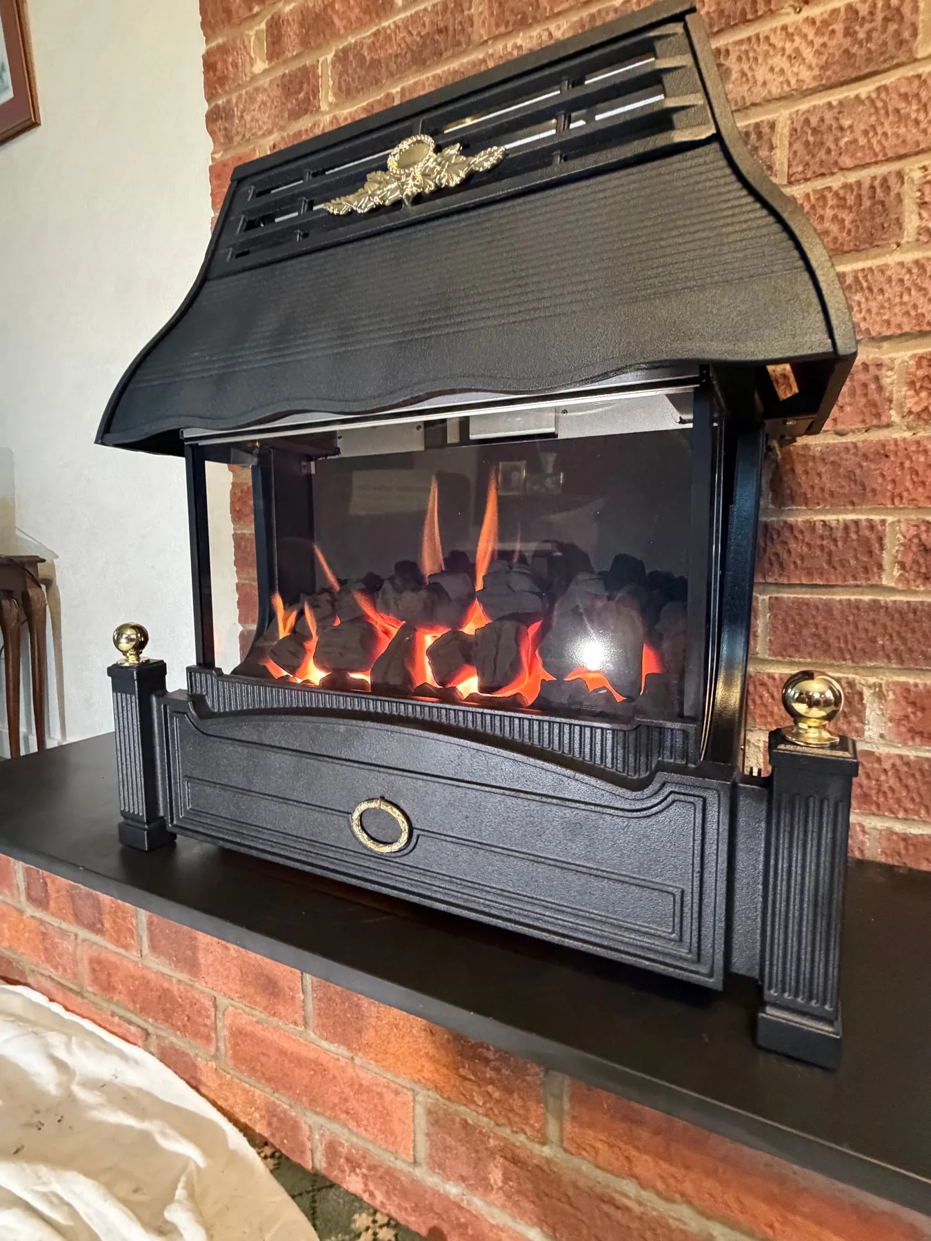 Traditional gas fire installed on a brick chimney breast, tested and running